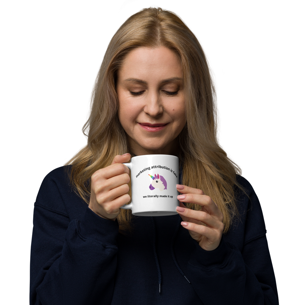 woman holding Marketing Attribution Is Fake News Mug in right hand